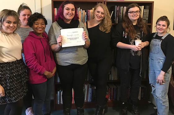 Photo of a group of female Chatham University students, posing together and smiling